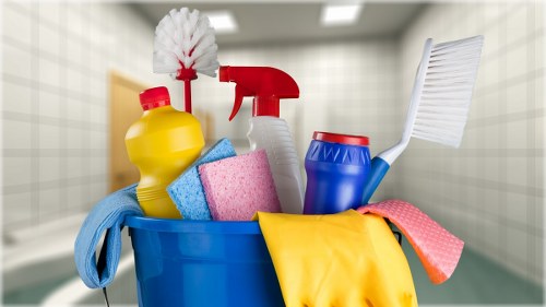Cleaner preparing carpet cleaning equipment in a safe working area