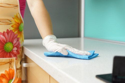 Local cleaner treating stains on a lounge sofa in Merton