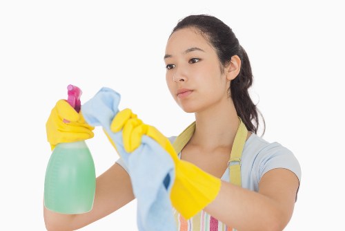 Professional office cleaner maintaining a business workspace in Merton